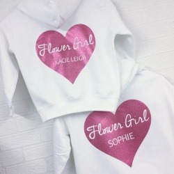 White zip up hoodie printed with a glitter heart and personalisation details.